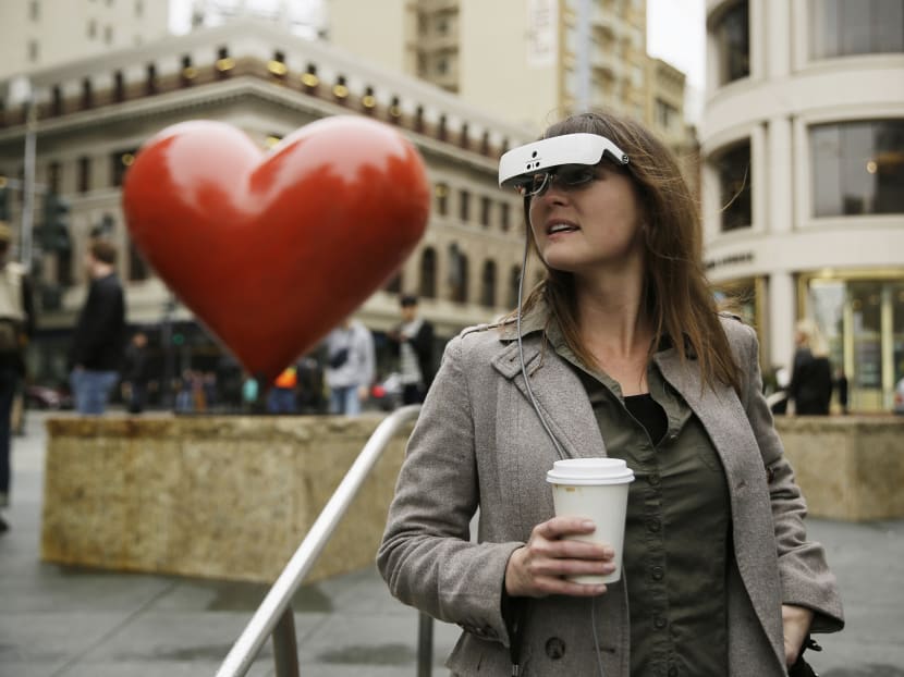 In this photo taken Thursday, Feb. 2, 2017, Yvonne Felix, of Canada, wears eSight electronic glasses and looks around Union Square during a visit to San Francisco. The glasses enable the legally blind to see. Felix was diagnosed with Stargardt Disease after being hit by a car at the age of seven and has lived without useful sight for 25 years. Photo: AP