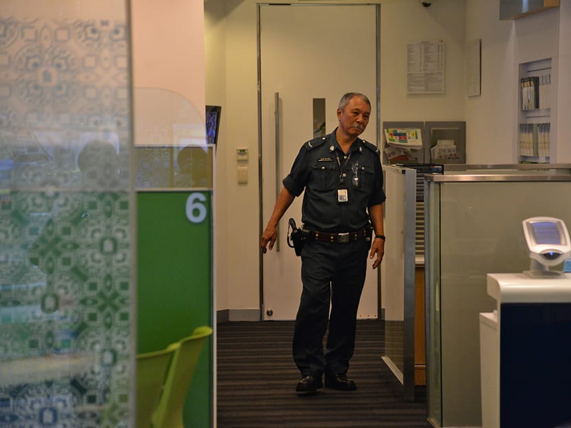 An auxiliary police officer in the Standard Chartered bank branch at Holland Village, on July 8, 2016. Photo: Robin Choo/TODAY