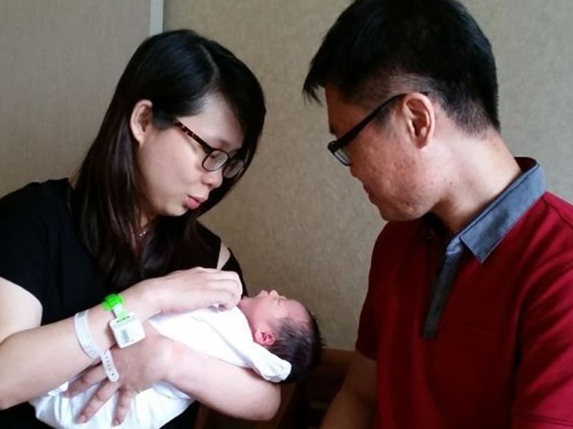 Kayley Foong, who was born at midnight on Christmas Day, with her parents. Photo: Loke Kok Fai, Channel NewsAsia