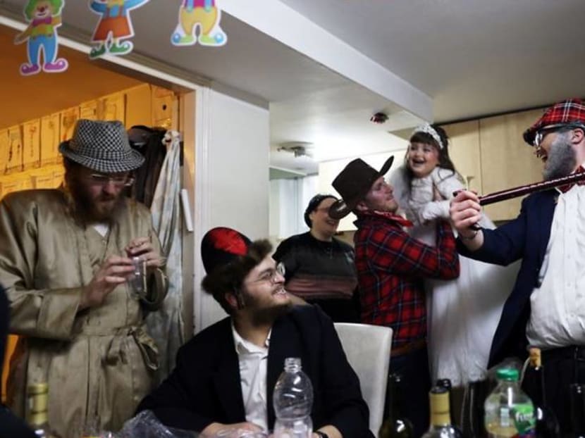 COVID curbs dampen carousing on Jewish costume festival Purim COVID curbs dampen carousing on Jewish costume festival Purim