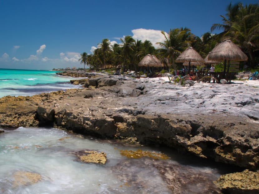 Tourists at shaded tables along a rocky spot on the Yucatan coast in Tulum, Mexico, on Aug 2, 2014. By virtue of language, ease of transportation, expense or level of hospitality, some international travel destinations are especially well-suited to solo travellers. Photo: The New York Times