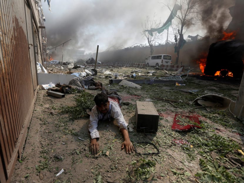 A wounded man lies on the ground at the site of a blast in Kabul, Afghanistan May 31, 2017. Photo: Reuters