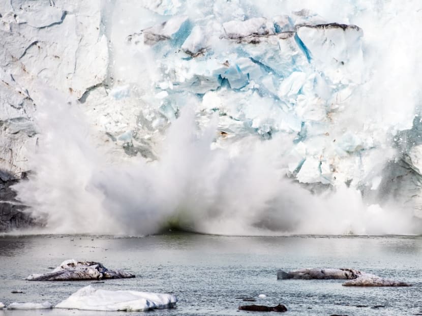 An iceberg calving with a mass of ice breaking away from the Apusiajik glacier, near Kulusuk, a settlement in the Sermersooq municipality located on the island of the same name on the southeastern shore of Greenland. An iceberg calving with a mass of ice breaking away from the Apusiajik glacier, near Kulusuk, a settlement in the Sermersooq municipality located on the island of the same name on the southeastern shore of Greenland.