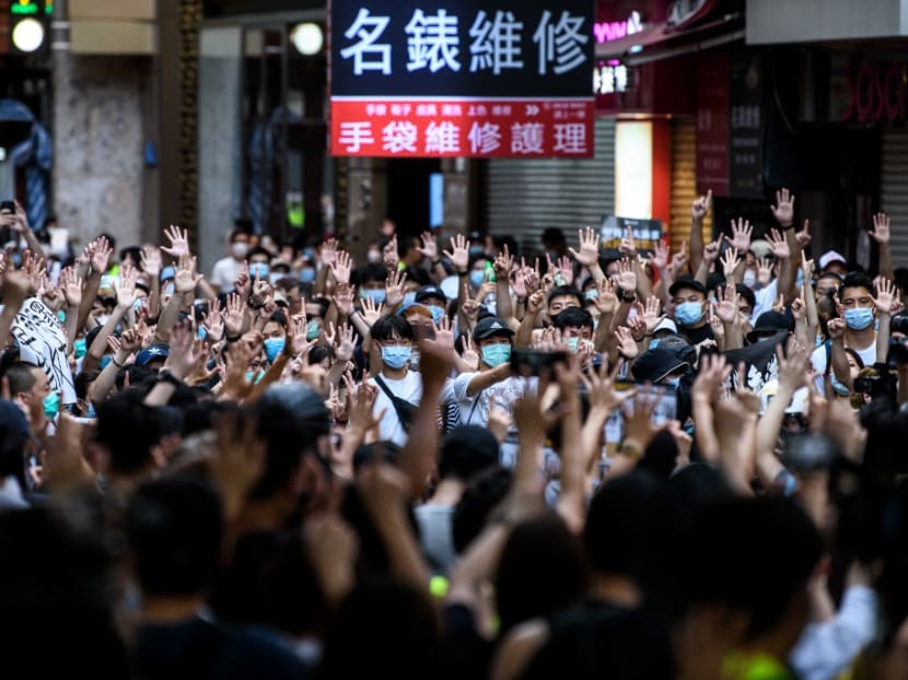 Protesters chant slogans and gesture during a rally against a new national security law in Hong Kong on July 1, 2020, on the 23rd anniversary of the city's handover from Britain to China. Protesters chant slogans and gesture during a rally against a new national security law in Hong Kong on July 1, 2020, on the 23rd anniversary of the city's handover from Britain to China.
