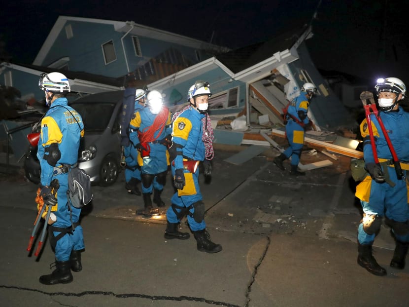 Police officers check a collapsed house after an earthquake in Mashiki town, Kumamoto prefecture, southern Japan, in this photo taken by Kyodo April 16, 2016. Photo: Reuters/Kyodo