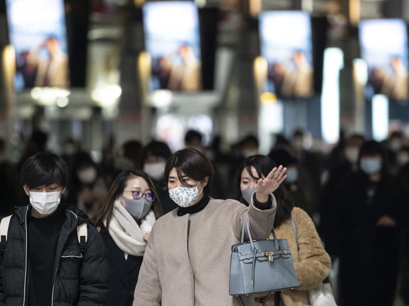 People walk at Shinagawa station in Tokyo on Jan 13, 2021.