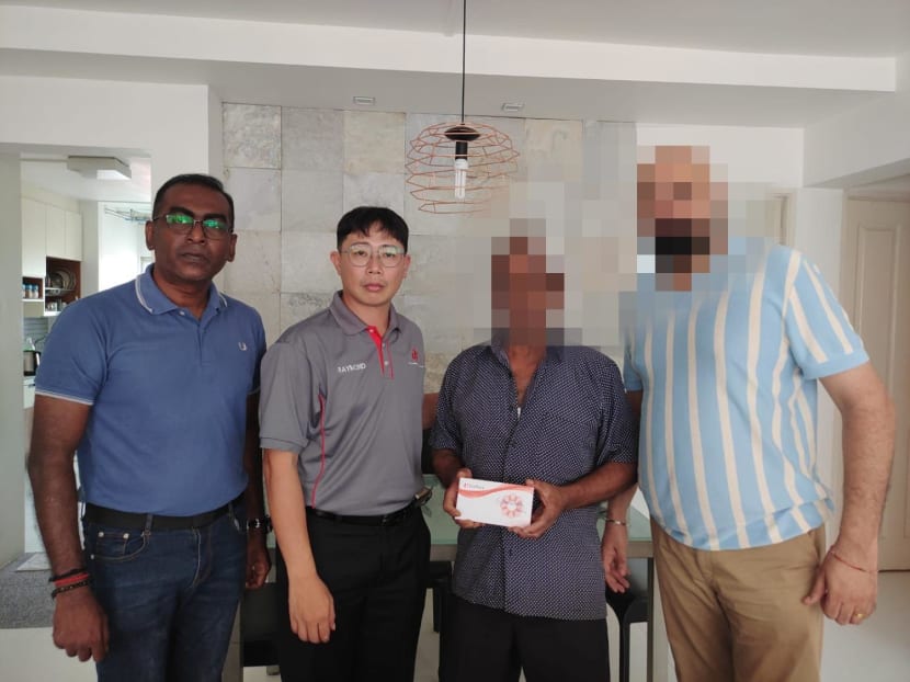 The Union of Security Employees' general secretary Raymond Chin (second from left), visiting a security guard who was injured (second from right) with the union's representatives on April 19, 2023. 