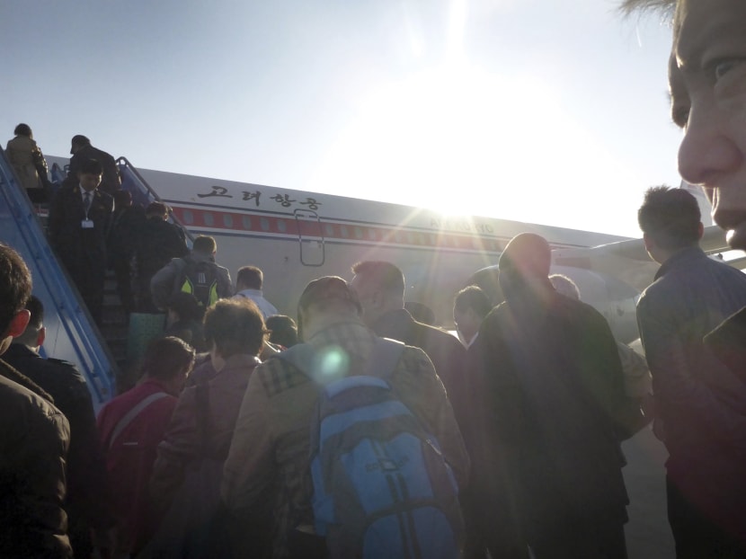 Passengers boarding an Air Koryo flight headed for Beijing, at the Sunan International Airport in Pyongyang, North Korea, on Oct 28, 2014. Photo: AP