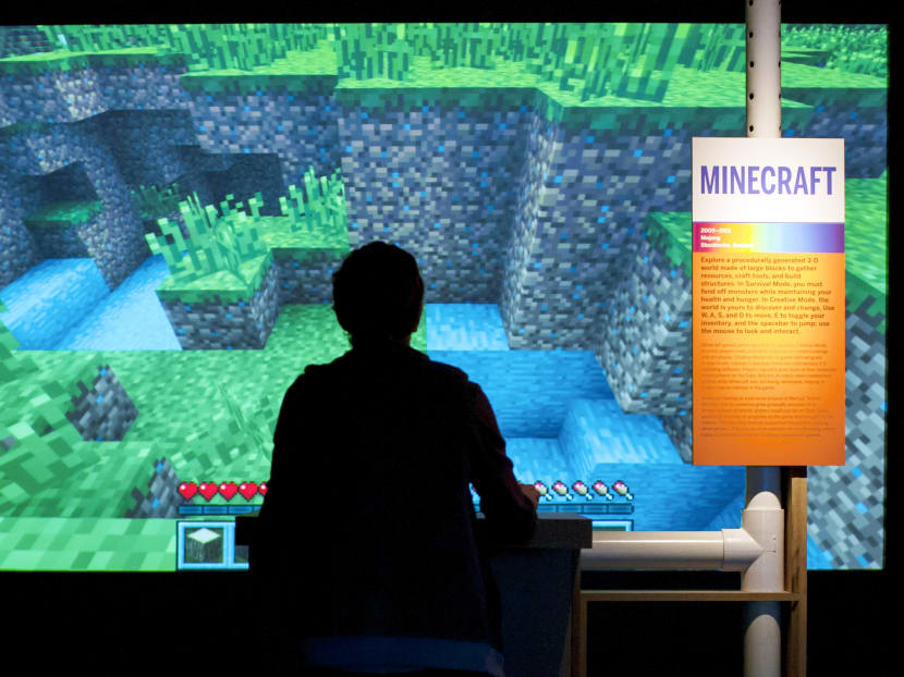 A gamer playing Minecraft at an exhibit at the Museum of the Moving Image in New York in 2013. Minecraft has become a global phenomenon by breaking with game conventions of flashy graphics and intricate storylines. Photo: 
The New York Times
