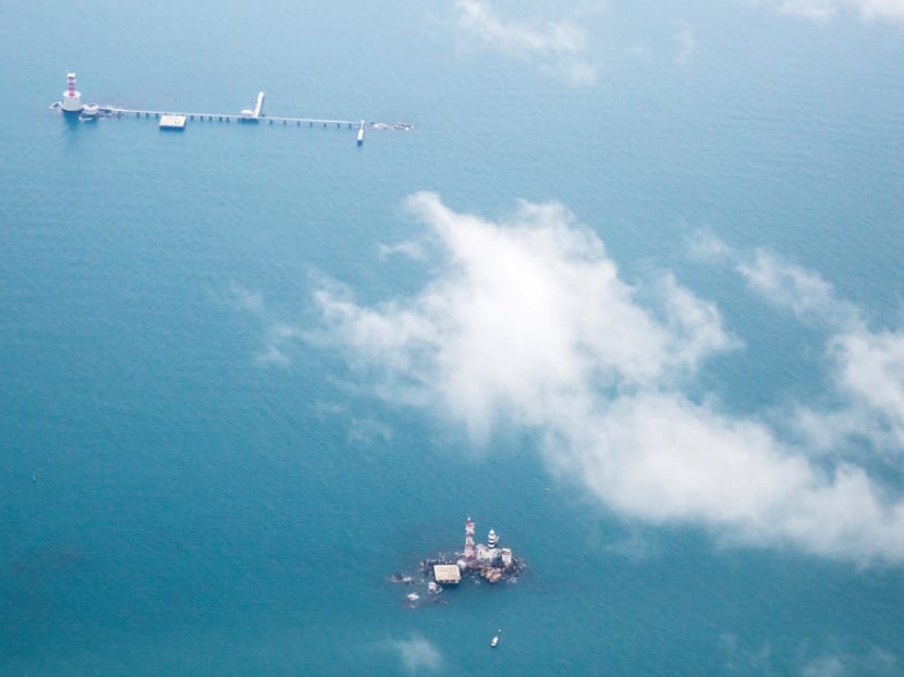 Malaysia has constructed a maritime base on Middle Rocks comprising a jetty linking the two main outcrops, a lighthouse and a helipad. The base lies close to Singapore's Pedra Branca, which can be seen at the bottom of this photo.