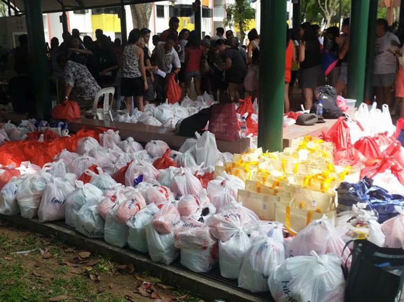 Volunteers of Happy People Helping People (HPHP) Foundation with ration packs for cardboard collectors in Toa Payoh. Mr Sapari says more must be done to ensure retirement adequacy for vulnerable low-wage workers here. Photo: Facebook/ Happy People Helping People