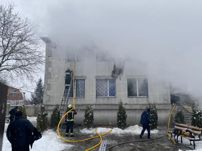 Firefighters work at the site of a fire in a nursing home in Kharkiv on Jan 21, 2021.