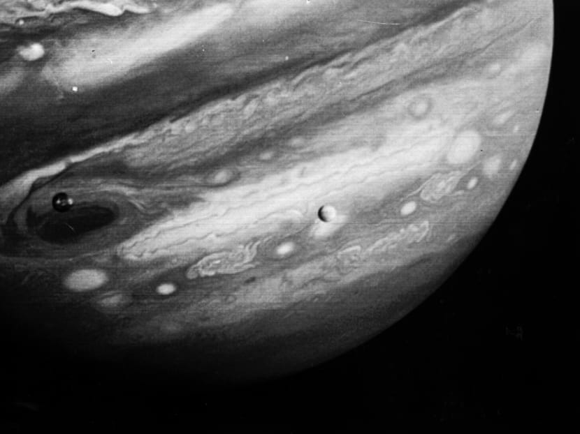 This 1979 photo released by NASA's Jet Propulsion Laboratory shows the planet Jupiter and two of its moons, Io (left) and Europa (centre). Photo: AP