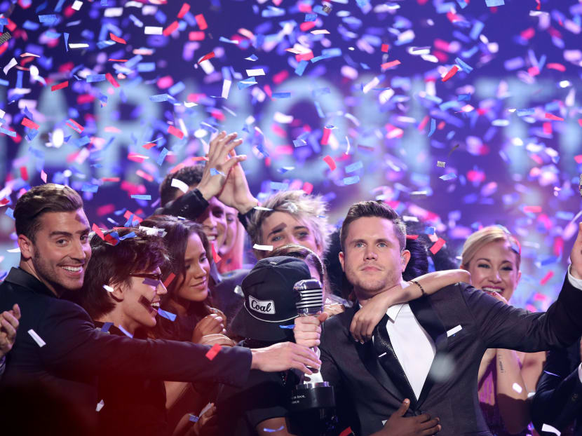 Trent Harmon, centre, winner of American Idol The Farewell Season celebrates with fellow contestants during the season finale at the Dolby Theatre on Thursday, April 7, 2016, in Los Angeles. Photo: AP