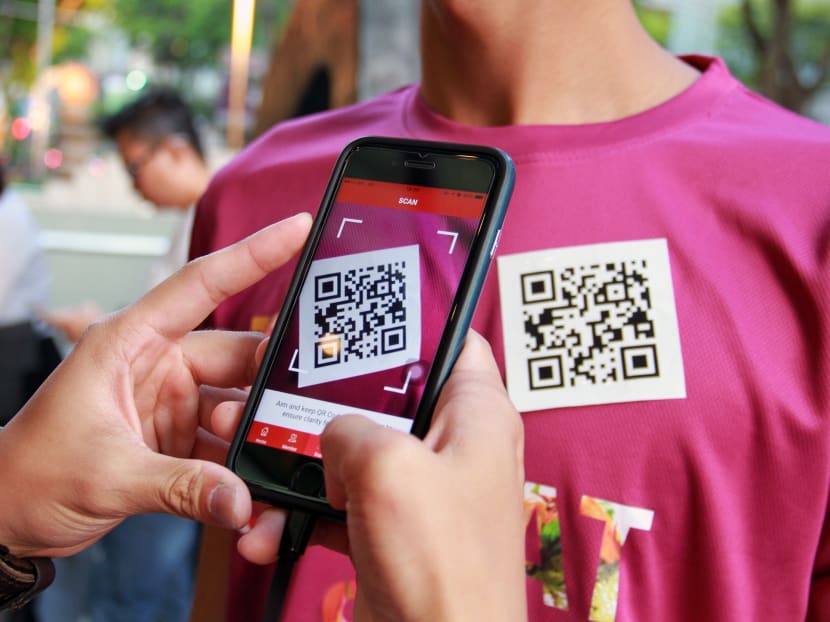Singapore Retailers Association launched the 24th edition of The Great Singapore Sale, on June 9, 2017, with a new digital moble application, GoSpree. A user is seen scanning the QR code to download the app. Photo: Esther Leong/TODAY