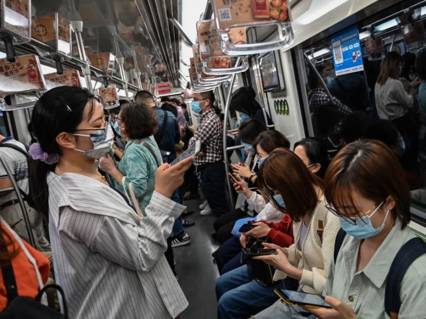 People travel on the subway in Shanghai on Oct 12, 2021.