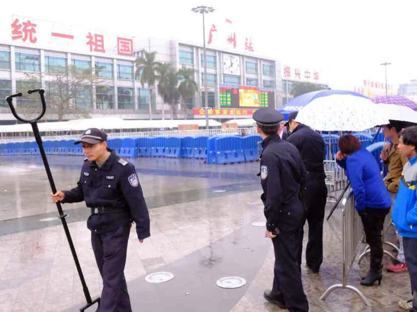 Police control the site after a knife attack outside the Guangzhou Railway Station. Photo: Reuters