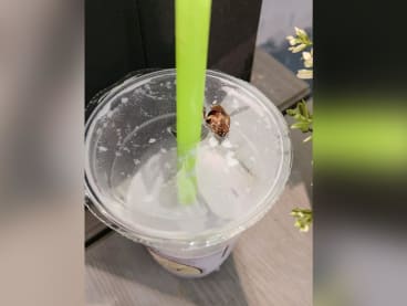 A photo posted by the Facebook user showing a cockroach on the plastic cover of the drink.