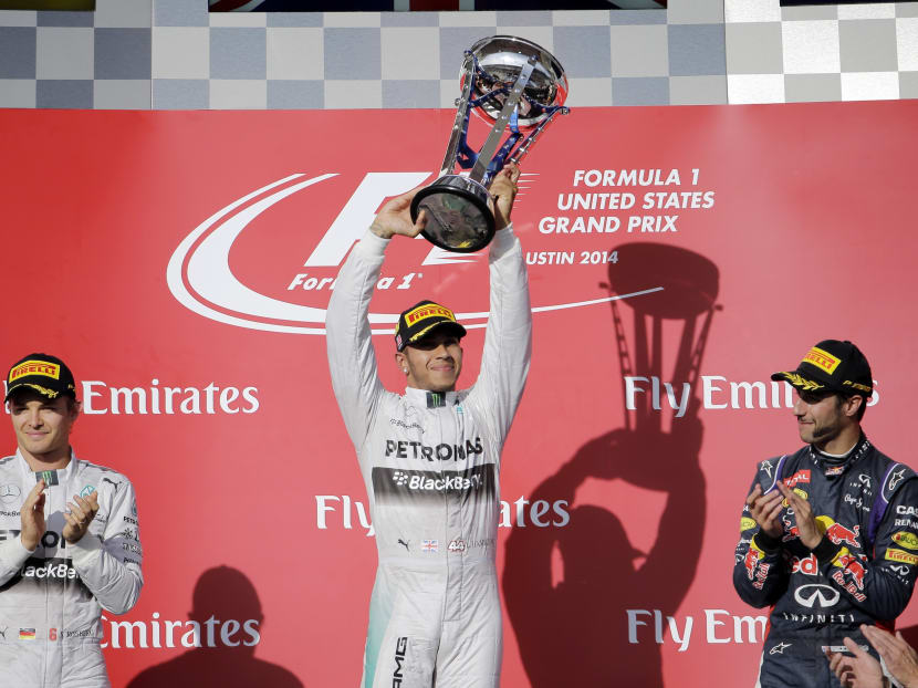 Race winner Mercedes driver Lewis Hamilton, of Britain, holds up his trophy. Photo: AP