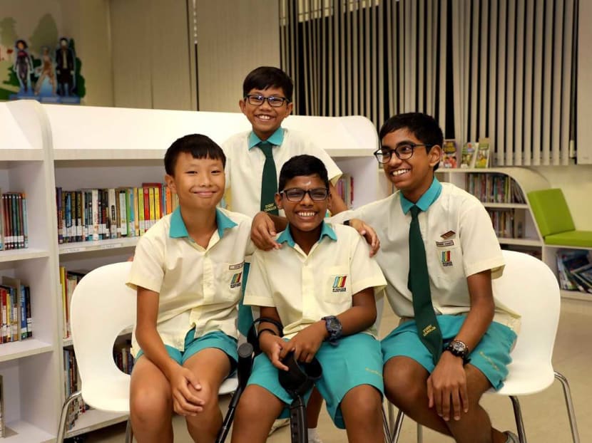 Durkeswaran Krishnan (seated, centre) overcame his fear of school to receive his PSLE results on Nov 21, 2019. His friends accompanied him on stage: (from left) David Goh Kai Kiat, Saifudeen Ahmed and (standing) Muhammad Irfan Azmai.