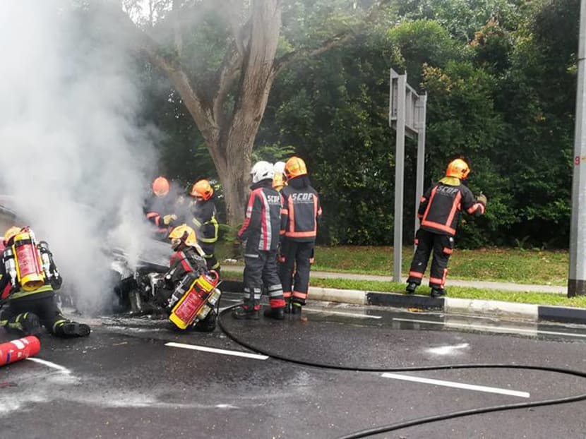 SCDF personnel putting out the TransCab fire along Moulmein Road. Photo: Loh Swee Meng/Facebook