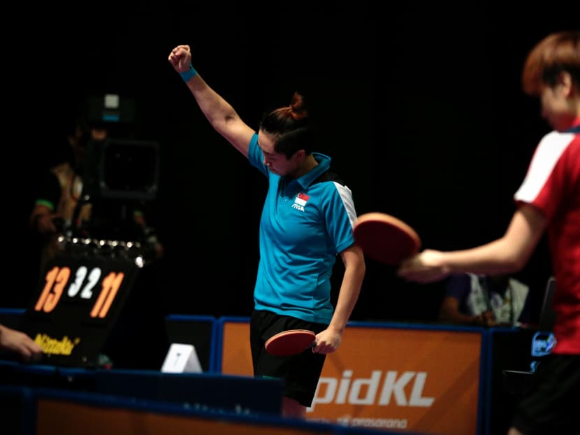 Feng Tianwei raising her arm in victory after beating teammate Zhou Yihan in the women's singles final. Photo: Jason Quah / TODAY