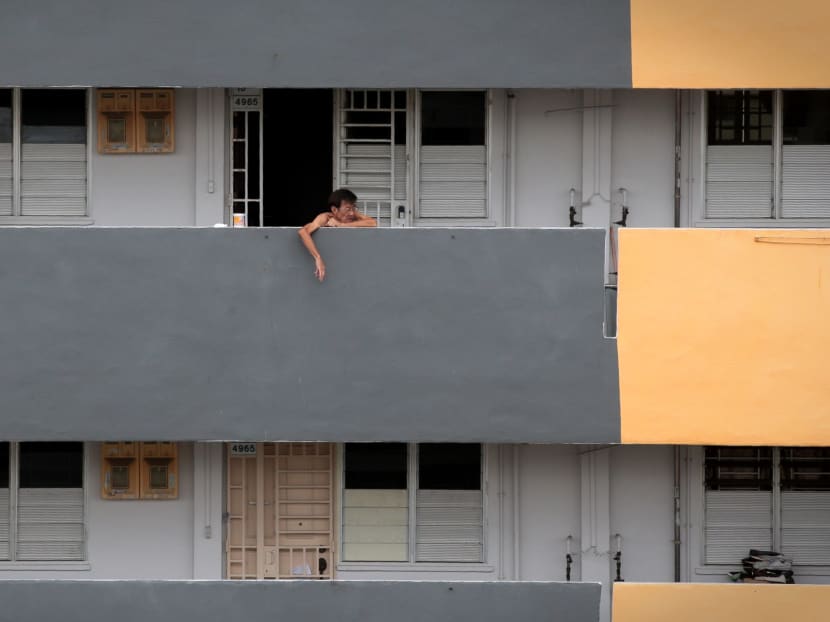 A resident at the common corridor of a two-room rental flat block along Ang Mo Kio Ave 6.
