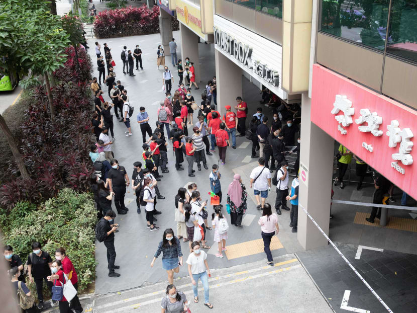 Crowds are seen outside Chinatown Point at about 12pm on March 12, 2021. Crowds are seen outside Chinatown Point at about 12pm on March 12, 2021.