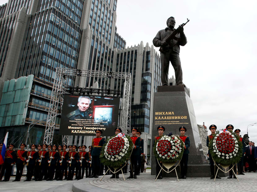 Guards of honour stand next to a monument to Mikhail Kalashnikov, the Russian designer of the AK-47 assault rifle, during its opening ceremony in Moscow. Photo: Reuters