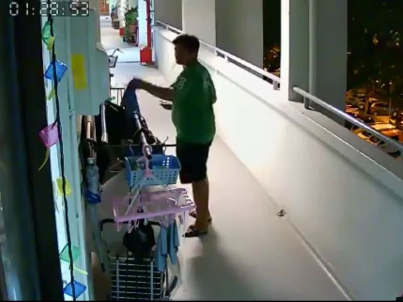 In a video posted on Facebook, a man wearing a GrabFood T-shirt is seen taking a towel off a clothes rack and walking away with it. In a video posted on Facebook, a man wearing a GrabFood T-shirt is seen taking a towel off a clothes rack and walking away with it.