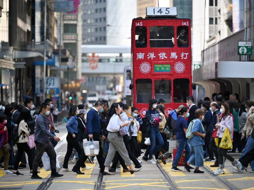 Pedestrians crossing a street in the central district of Hong Kong.
