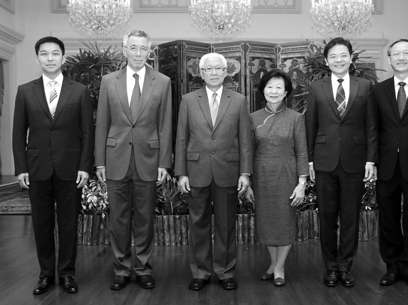 Prime Minister Lee Hsien Loong and President Tony Tan (centre) with ministers Tan Chuan-Jin (far left) and Mr Lawrence Wong (second from right), two ministers who belong to the 4G leadership, after a swearing-in ceremony at The Istana last year. 4G leaders have started moving up to key appointments. Photo: Don Wong