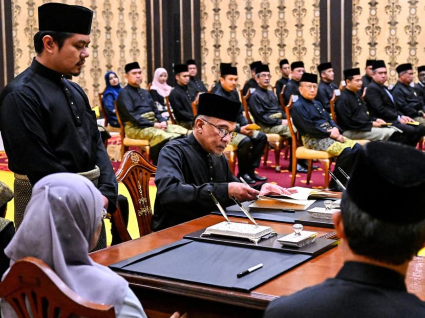 Mr Anwar Ibrahim (seated at far end of desk) at the swearing-in ceremony at the National Palace in Kuala Lumpur on Nov 24, 2022 after he was appointed as Malaysia's new prime minister.