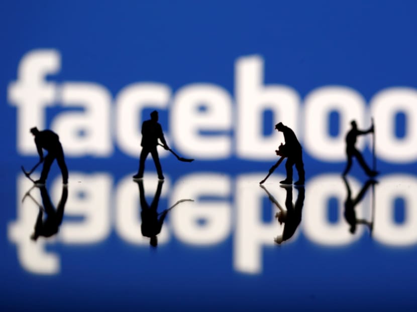 Figurines are seen in front of the Facebook logo. News that political data firm Cambridge Analytica was able to gain access to private data through Facebook has prompted many users to abandon the social networking site. Photo: Reuters
