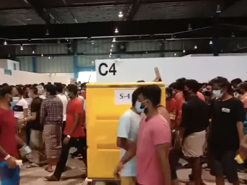 A screengrab of a video, which has been going around chat groups and social media, showing migrant workers getting their meals at food stations in Changi Exhibition Centre. A screengrab of a video, which has been going around chat groups and social media, showing migrant workers getting their meals at food stations in Changi Exhibition Centre.