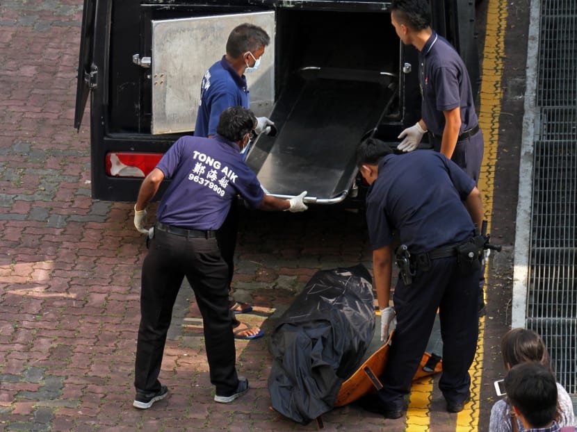 The corpse being loaded onto a police van. A woman was found murdered on Sept 3, 2015, in a car park in Toa Payoh. Photo: Jaslin Goh