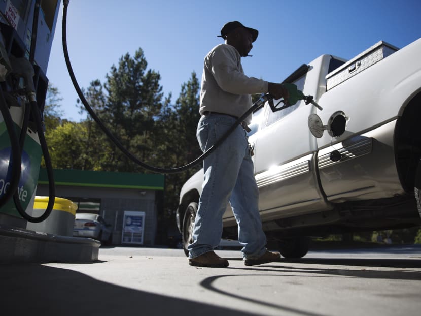 In this Oct 30, 2014 file photo, motorist Jerry Reed fills up his tank at a gas station in Atlanta. Photo: AP