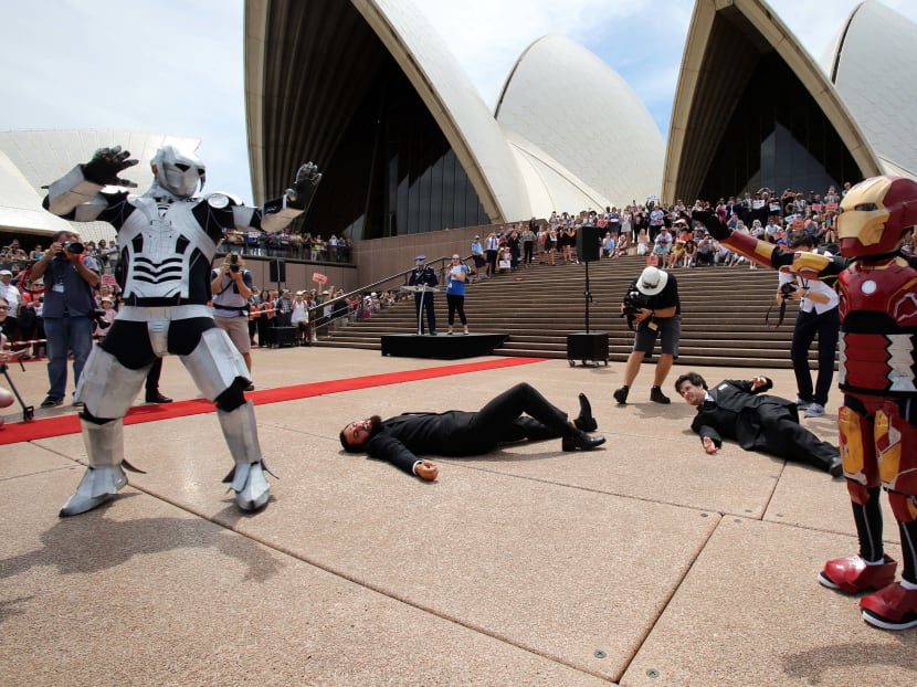 Nine-year-old Domenic Pace acting out a scene as he is granted his wish to become a superhero like Iron Man, with police staging an elaborate event on the Sydney Opera House steps. Photo: AFP/New South Wales Police