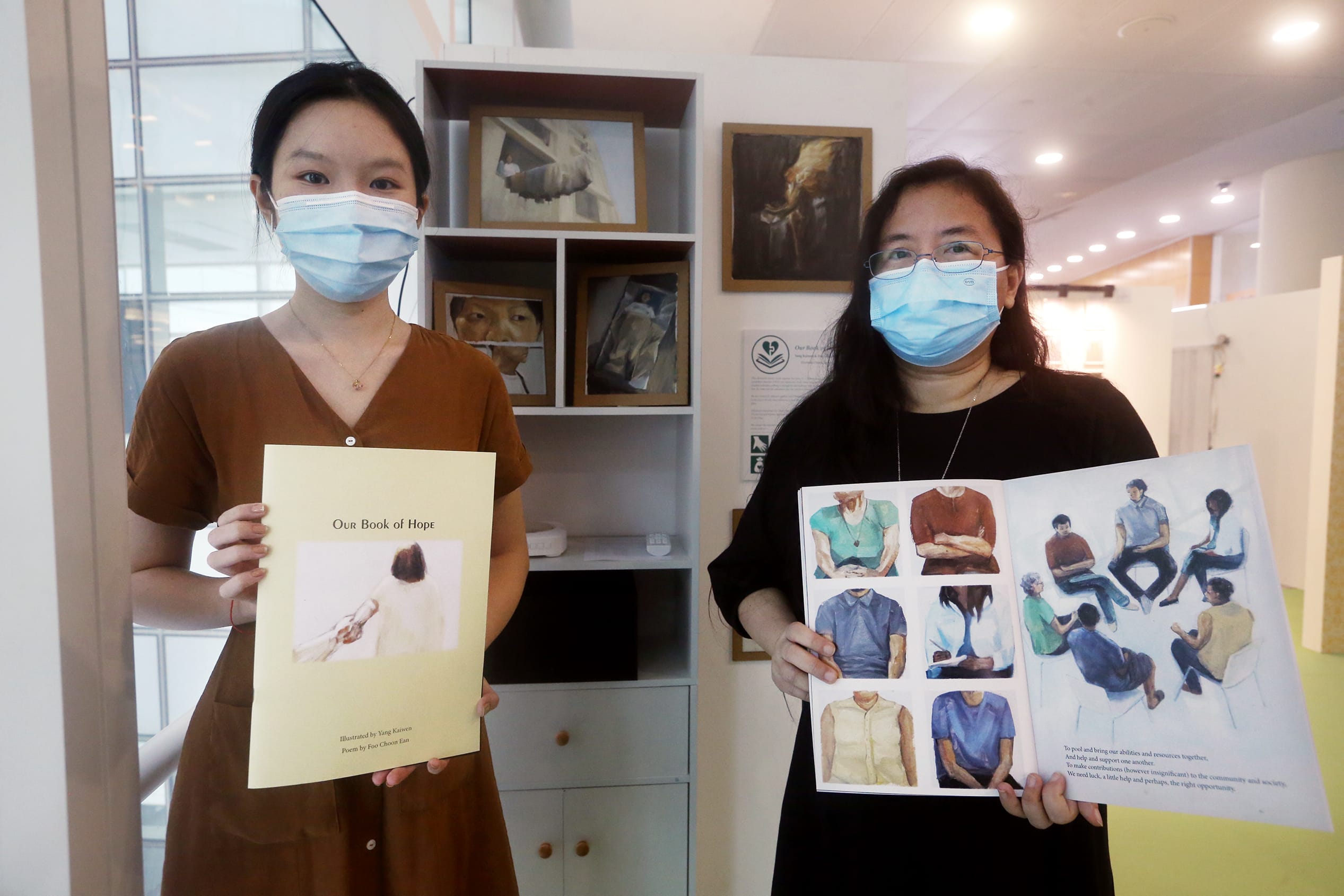 Yang Kaiwen (right) and Foo Choon Ean with the picture book they created to showcase Ms Foo’s OCD, entitled Our Book of Hope, at the Mental Health Collective SG Exhibition on Dec 19, 2021.