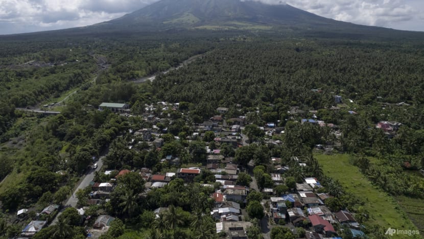 Poor villagers risk their lives in danger zone as Philippines' most active volcano erupts