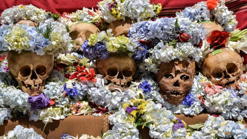 Bolivia's smoking skulls adorned with flowers, wigs and a Grim Reaper Bolivia's smoking skulls adorned with flowers, wigs and a Grim Reaper