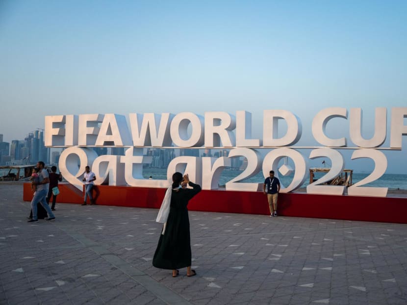 Visitors take photos with a Fifa World Cup sign in Doha on Oct 23, 2022, ahead of the Qatar 2022 Fifa World Cup football tournament.