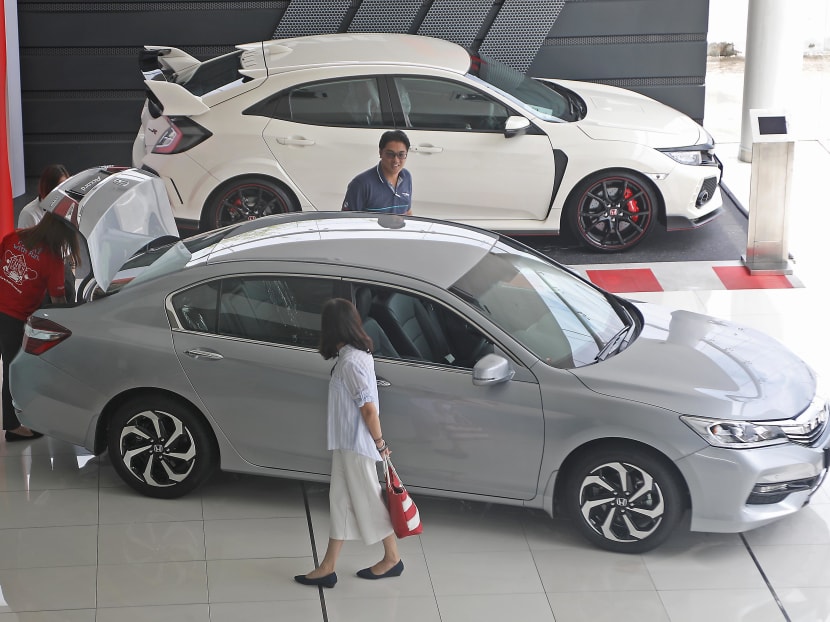 Potential customers looking at a car at a Honda showroom in Seremban, Negeri Sembilan. The three month tax holiday between the abolishment of Malaysia's Goods and Services Tax (GST) and the kicking in of the new sales tax regime on September 1 has seen soaring sales for new vehicles.