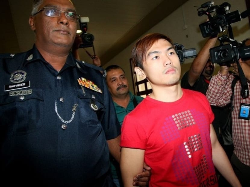 Malaysian sex blogger Alvin Tan (centre) is escorted by Malaysian police as he arrives at the High Court in Kuala Lumpur on July 18, 2013. Photo: AFP