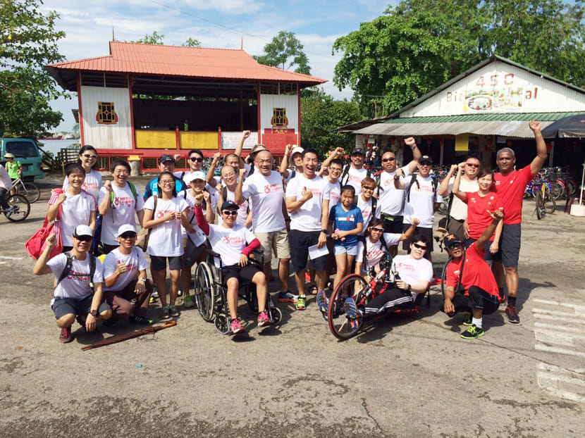 Mr Dennis Quek and Mr Wilson Ang (centre) with participants of Wheels @ Ubin on June 26, an initiative aimed at drawing attention to the issue of accessible travel by taking 100 wheelchair users to Pulau Ubin. Photo: Wheels @ Ubin
