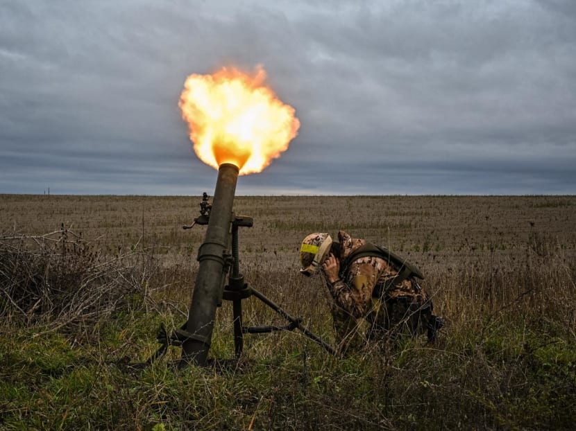 A member of Ukrainian National Guard fires a mortar launcher at a position along the front line in Kharkiv region on Oct 25, 2022.