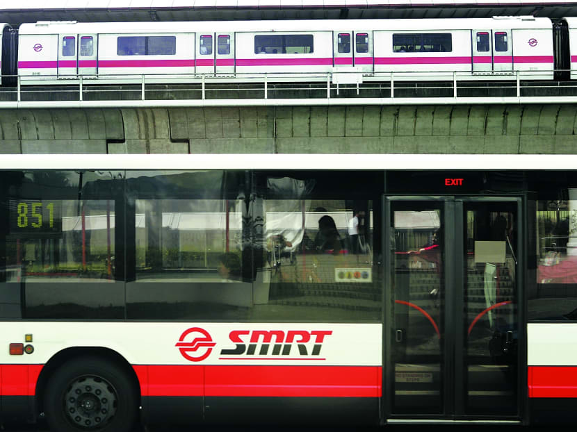 SMRT bus driving by an MRT train. Photo: Ooi Boon Keong