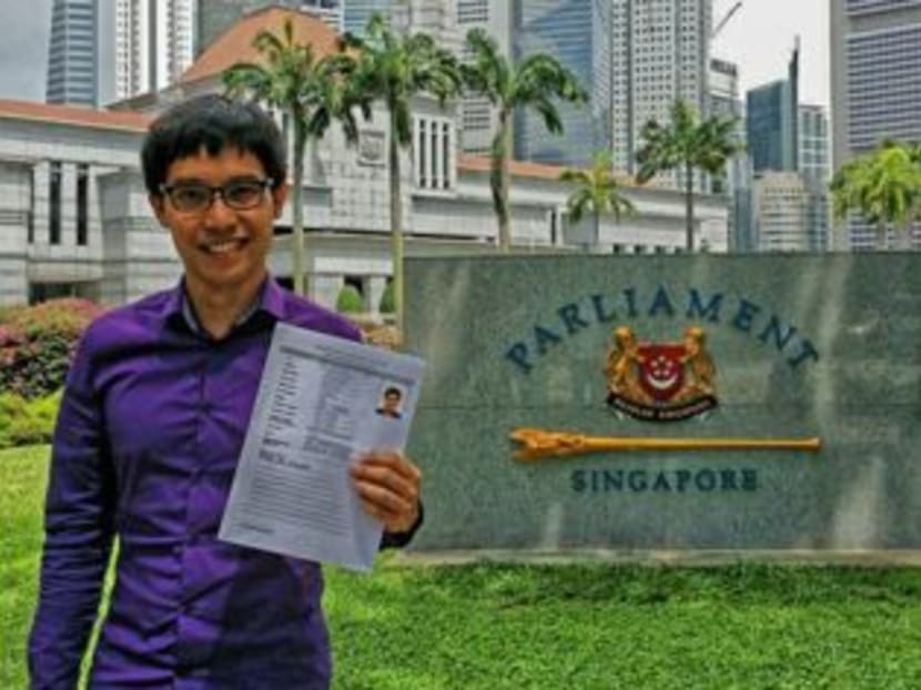Blogger Roy Ngerng holding his NMP application outside Parliament House. Photo: Roy Ngerng's Facebook page.