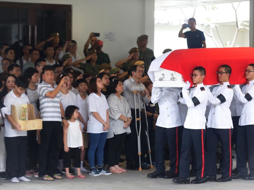 Soldiers carrying the coffin of full-time national serviceman Dave Lee Han Xuan into the hall at Mandai Crematorium during his military funeral in May 2018.