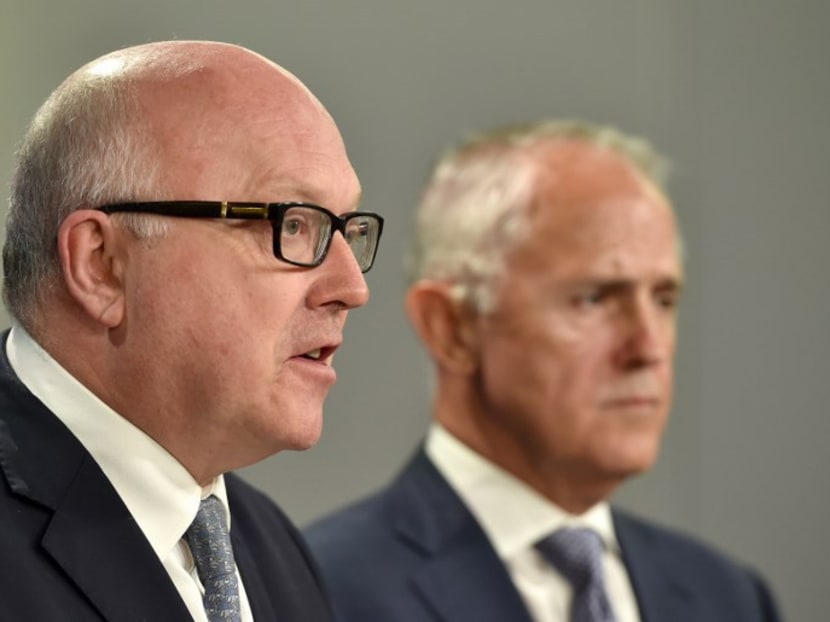 Australia’s Attorney General George Brandis (L) speaks at a press conference while Prime Minister Malcolm Turnbull looks on. Mr Brandis says the government will introduce a milestone legislative package to reform Australia’s espionage and foreign interference legislation. Photo: AFP